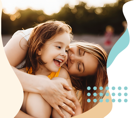 "Mother embracing and laughing with her young daughter outdoors, framed by Clearpath's teal dot pattern."