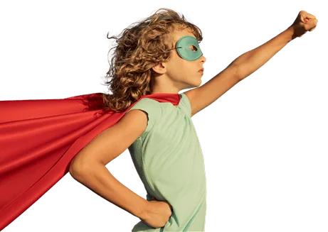 Child dressed as a superhero with a red cape and mask, striking a confident pose with fist raised.