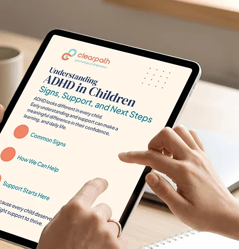 Hands holding a tablet displaying Clearpath's guide 'Understanding ADHD in Children: Signs, Support, and Next Steps.'